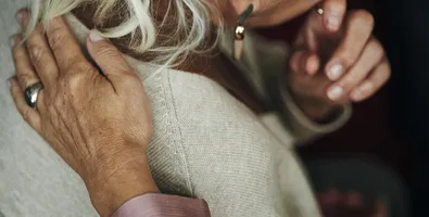 A person being comforted by a friend during a time of grief