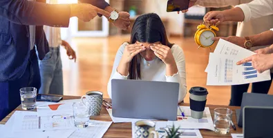 A person looking stressed at a workplace desk