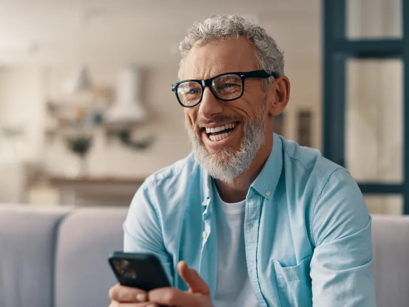 man smiling with phone