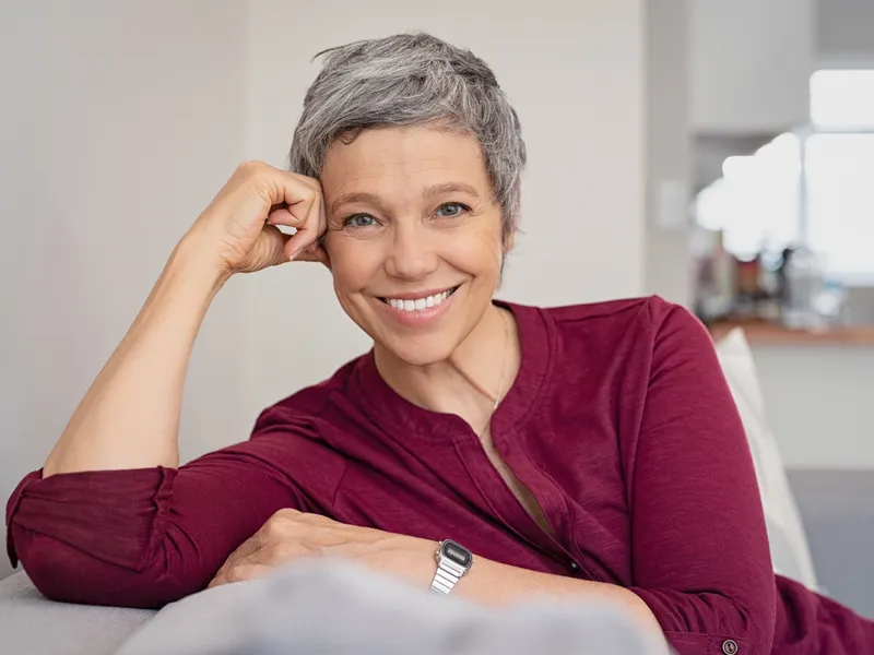 woman smiling sitting on couch