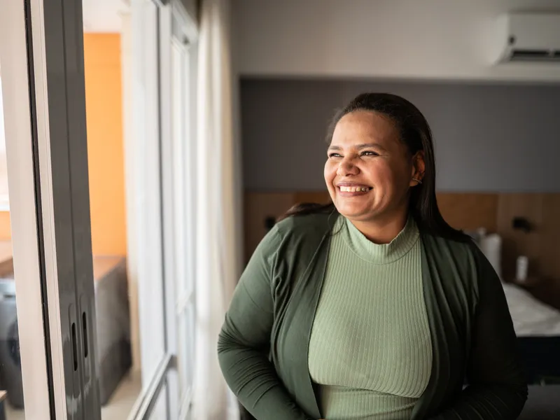 woman laughing by window