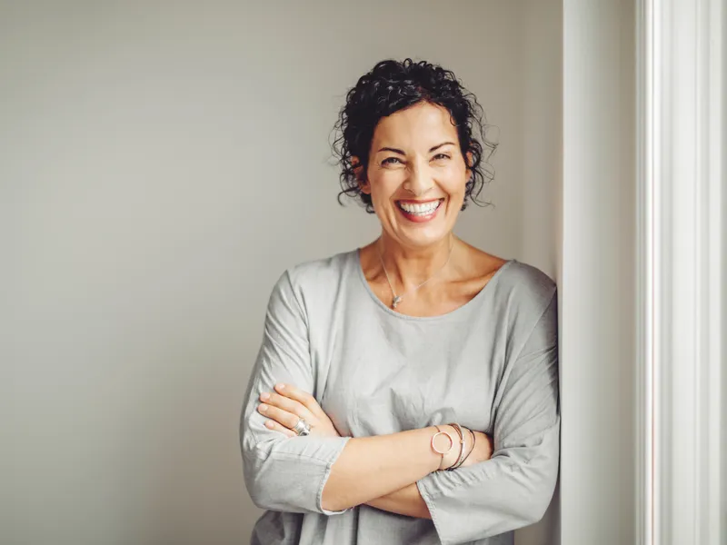 woman laughing leaning on window frame