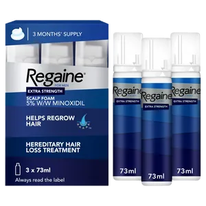 Triple pack of regaine foam for men front view of pack with three bottles standing next to the pack